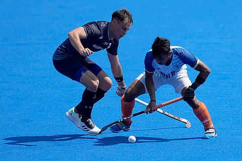 Vivek Sagar Prasad and Thomas Habif battle for the ball 